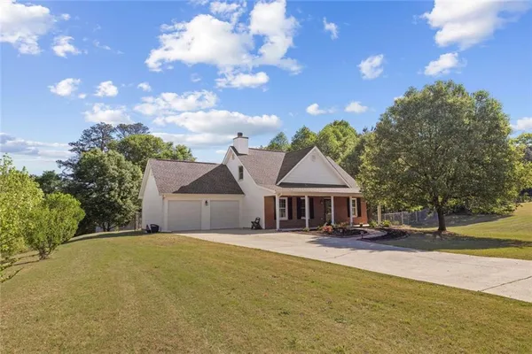 a front view of a house with a big yard