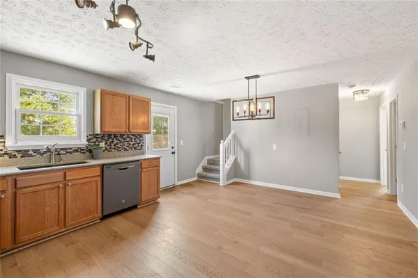 a view of a kitchen with a sink and a window