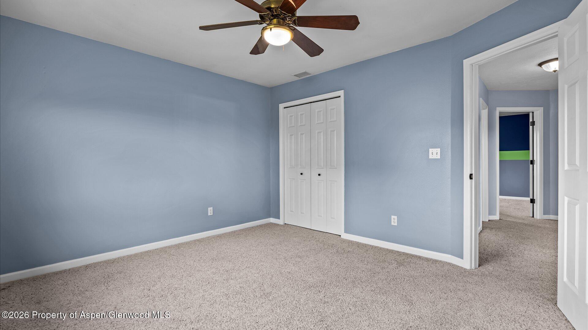 1459 Anvil View Avenue Rifle, CO 81650 - Photo 19 of 29 an empty room with closet and a chandelier fan