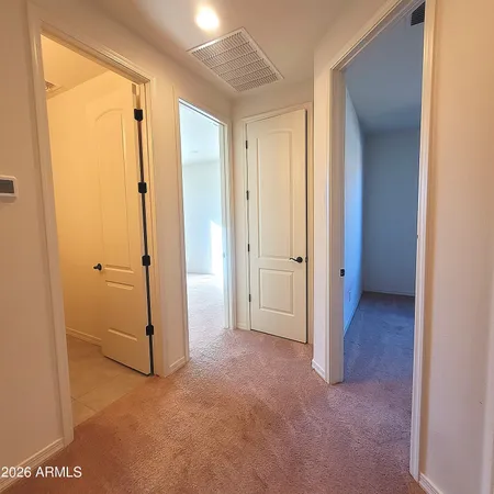 an empty room with closet and a bathroom view