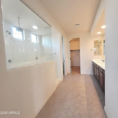 a bathroom with a glass shower door