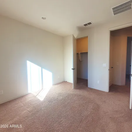 a view of an empty room and a window