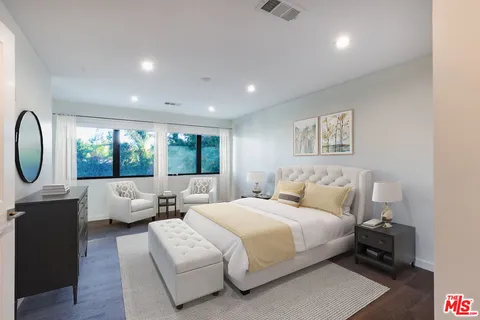 a bedroom with a large bed and a large window