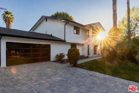 a view of a house with a yard and garage