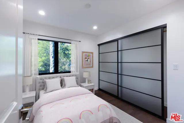 a spacious bedroom with a bed and a large window