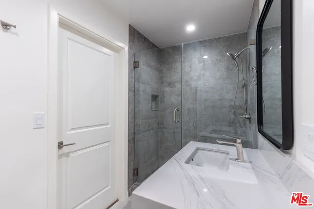 a bathroom with a shower and a sink