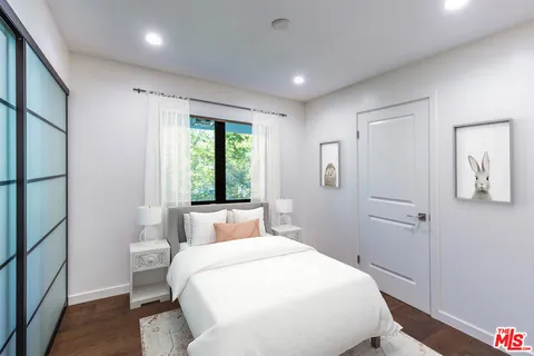 a bedroom with a large bed and a window