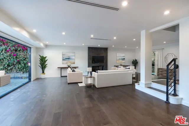 a living room with furniture and flowers