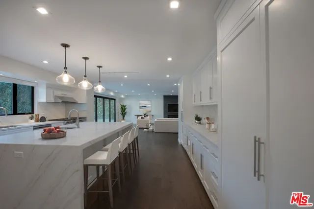 a large kitchen with a large counter top appliances and cabinets