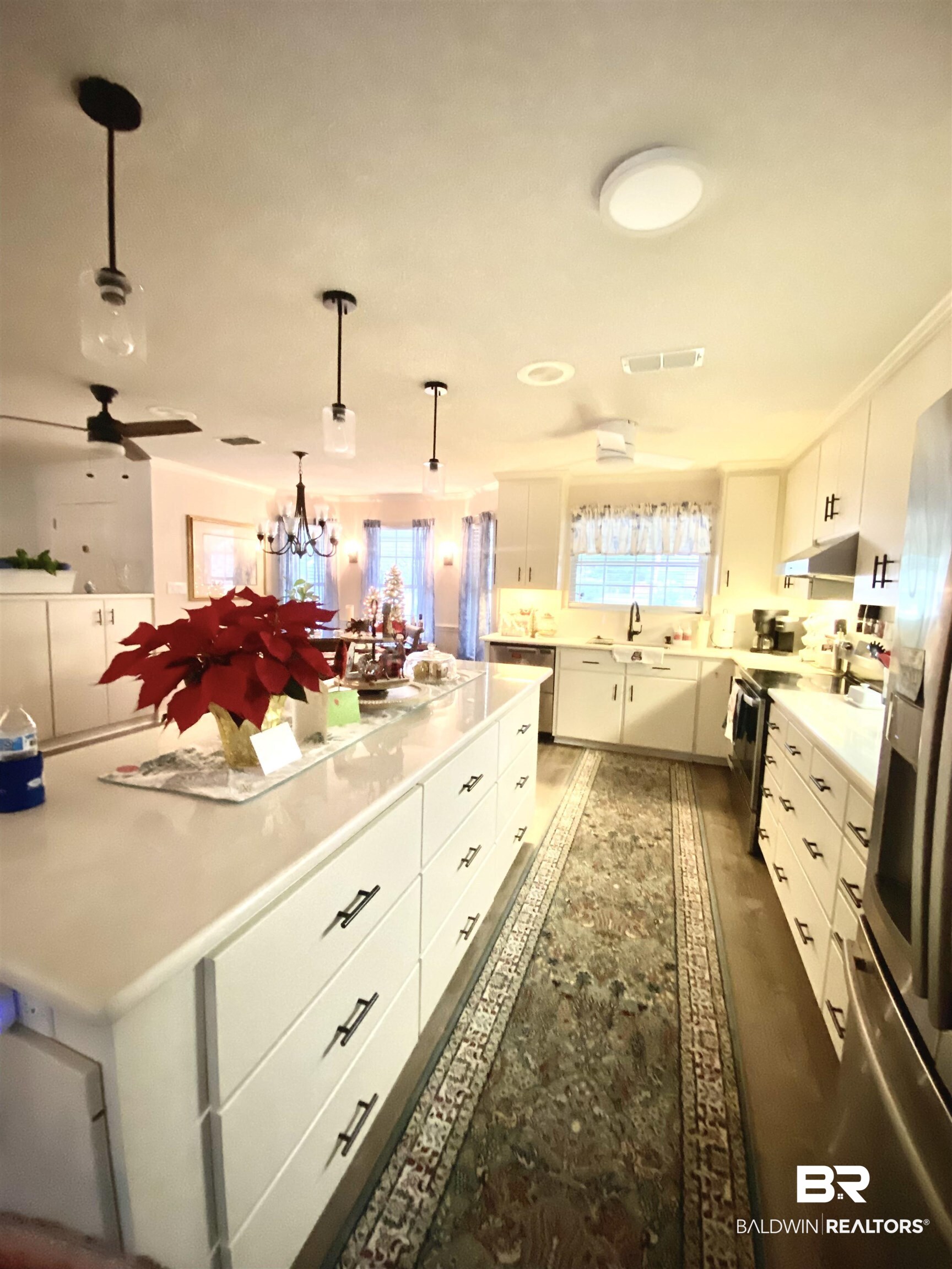 2872 Avenida Alberto Lillian, AL 36549 - Photo 9 of 31 Kitchen with pendant lighting, white cabinets, ceiling fan with notable chandelier, appliances with stainless steel finishes, and dark hardwood / wood-style flooring
