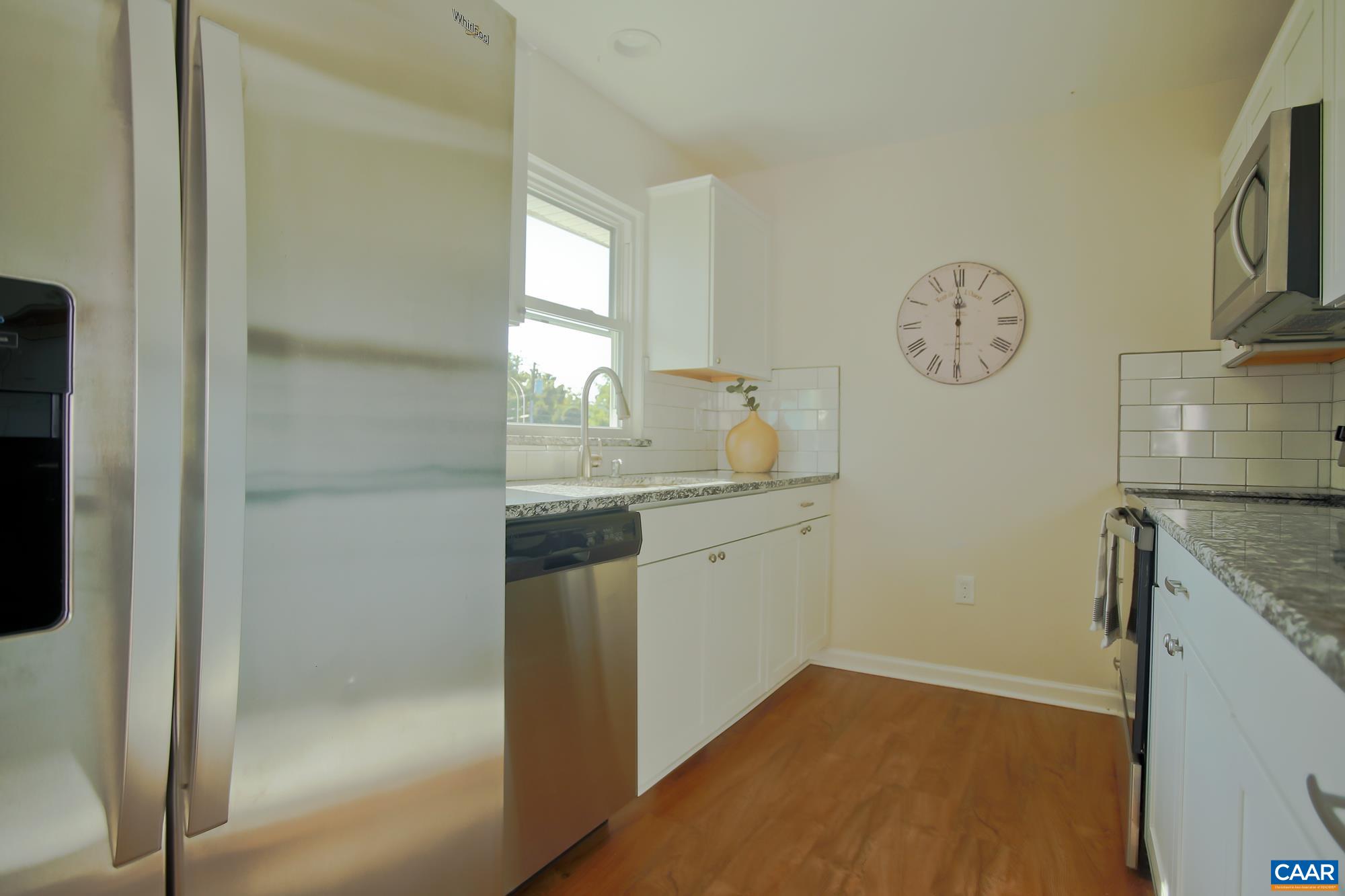 814 Raymond Road Charlottesville, VA 22902 - Photo 6 of 26 a bathroom with a granite countertop sink and a mirror