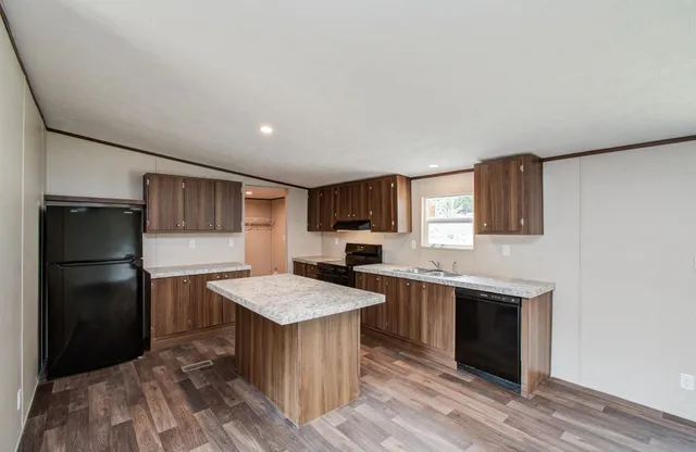 a kitchen with a refrigerator and a sink