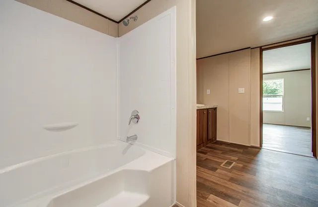 a bathroom with a bathtub and a shower