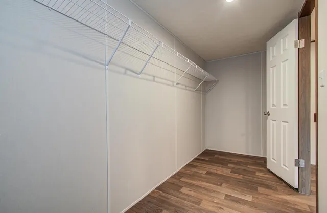 a view of a room with wooden floor