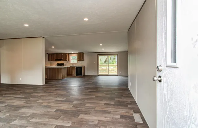 a view of a kitchen with a sink and a refrigerator