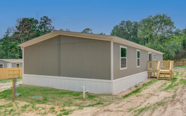 a back view of a house with a yard