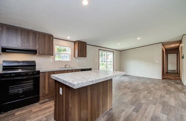 a kitchen with a stove a sink and a refrigerator