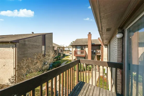 a view of a balcony with furniture