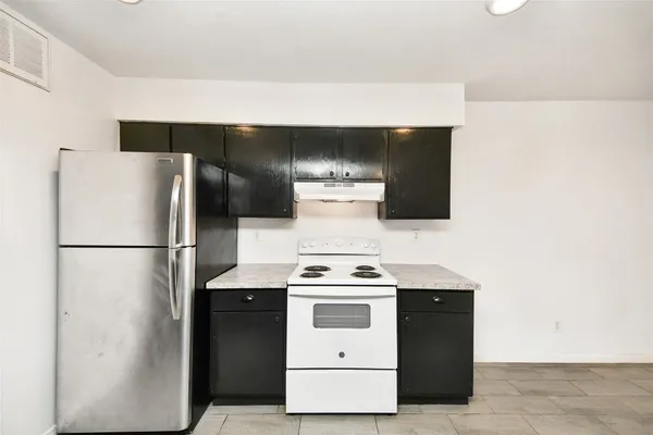 a white refrigerator freezer sitting in a kitchen
