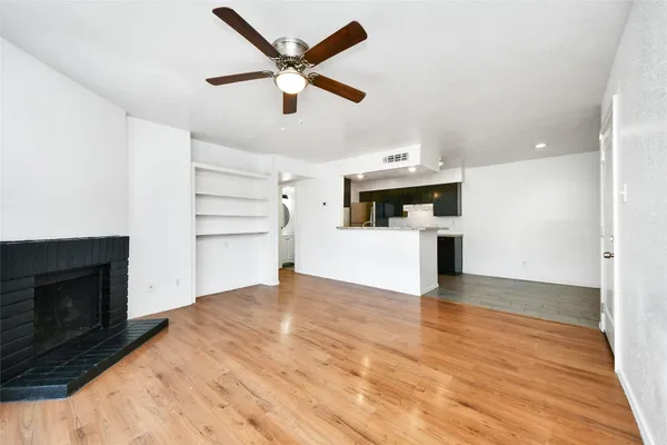 a view of a kitchen with a sink oven cabinets and empty room