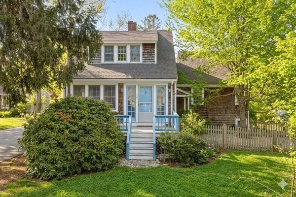 a front view of a house with a garden