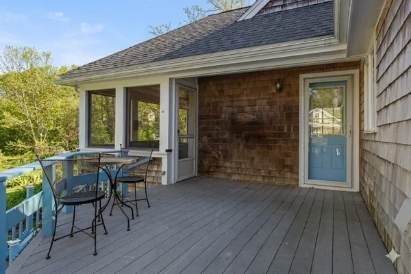 a view of a patio with table and chairs