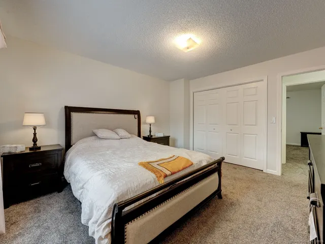 a bedroom with a bed and a lamp