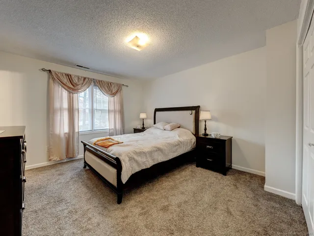 a bedroom with a bed lamp and window
