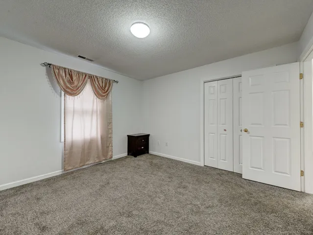a view of an empty room and a cabinet