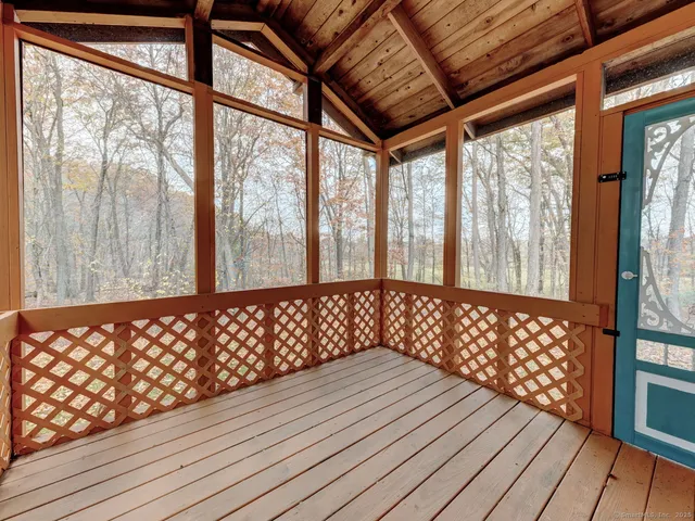 a wooden bench sitting in front of a window