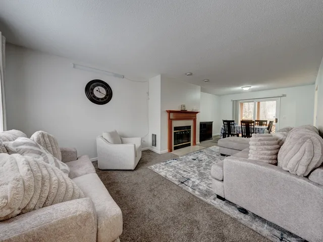 a living room with furniture kitchen view and a couch