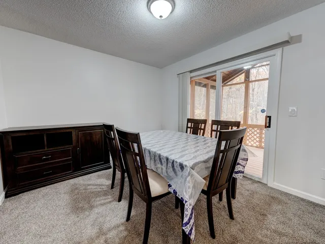 a view of a dining room with furniture and a window