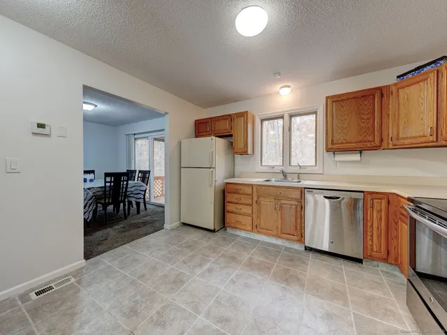 a kitchen with refrigerator and cabinets