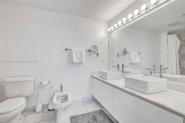 a bathroom with a toilet and a bathtub