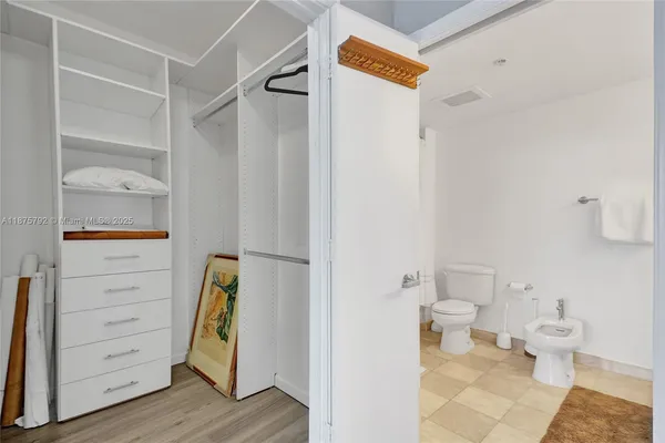 a view of walk in closet with empty racks