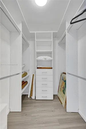 a kitchen with a refrigerator and a stove top oven