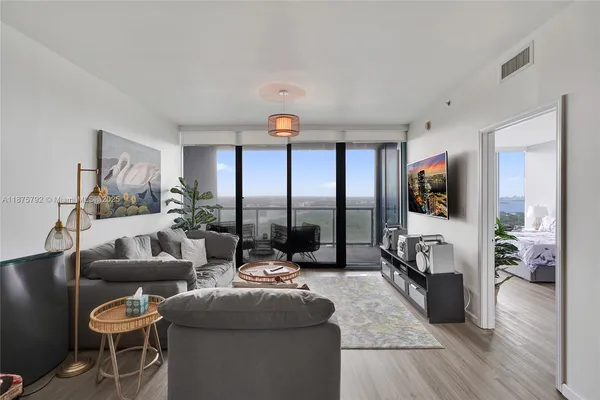 a living room with furniture and a large window