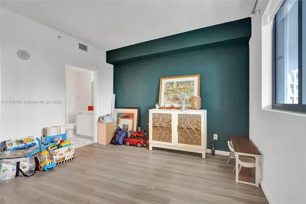 a bathroom with a sink toilet vanity and shower