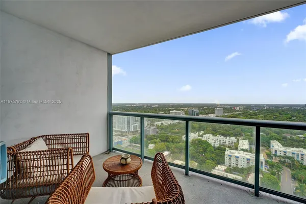 a living room with furniture and a floor to ceiling window