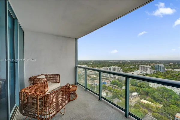 a balcony with table and chairs