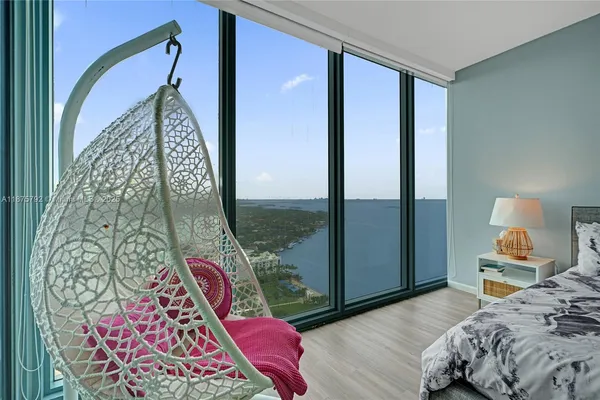 a bedroom with bed and a potted plant