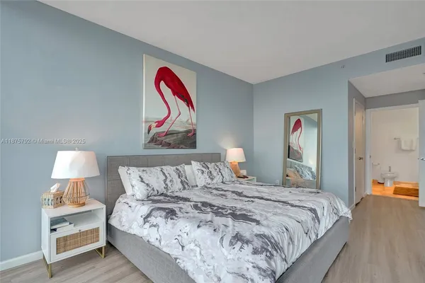 a bathroom with a granite countertop sink a toilet and a mirror