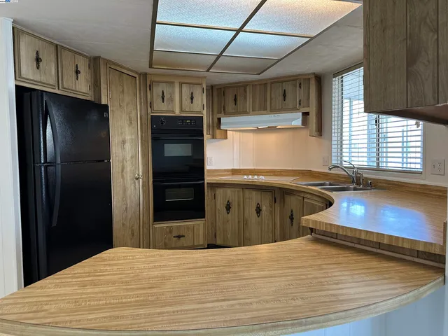 a sink with granite countertop a sink and a cabinets