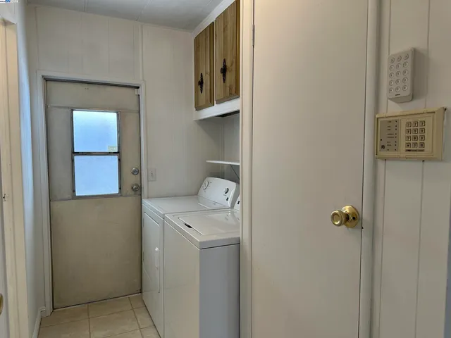 an empty room with cabinet and mirrors