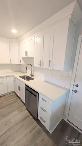 a kitchen with a sink cabinets and window