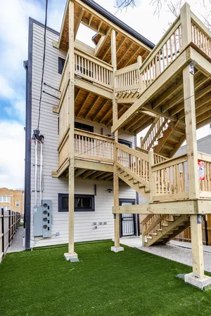 a front view of a house with a garden and deck