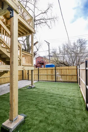 a view of a garden with large trees