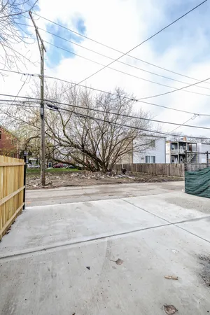 a view of a yard with cars parked on road