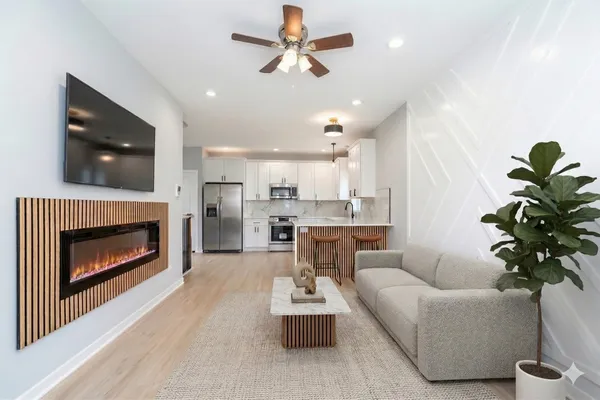 a living room with furniture a fireplace and a flat screen tv