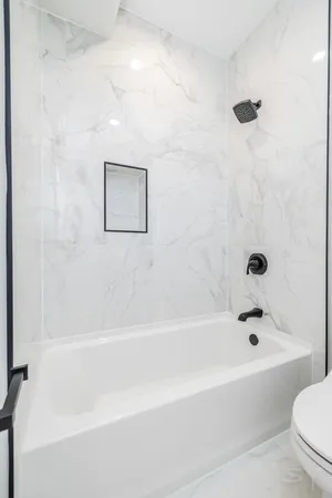 a bathroom with a bathtub and a toilet